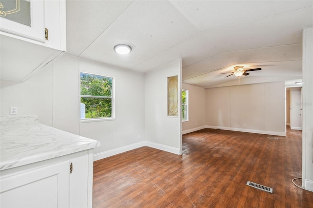 unfurnished living room featuring ceiling fan, dark hardwood / wood-style flooring, and lofted ceiling