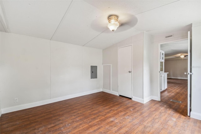 interior space with electric panel, ceiling fan, wood-type flooring, and vaulted ceiling