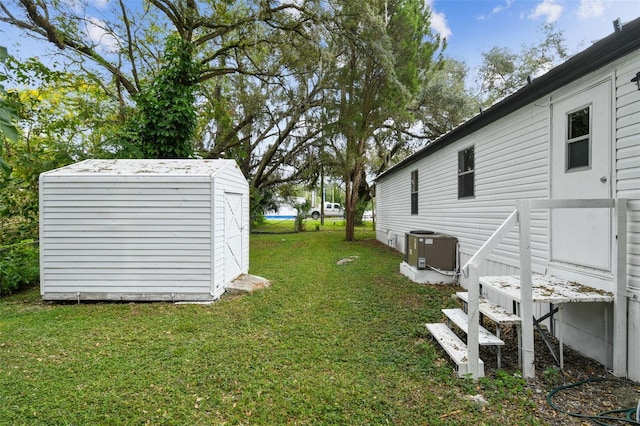 4611 Gall Blvd, Zephyrhills, FL 33542 - view of yard with an outdoor structure, cooling unit, and a shed