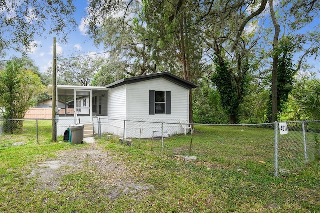 4611 Gall Blvd, Zephyrhills, FL 33542 - view of side of home with a sunroom, a lawn, and a fenced backyard