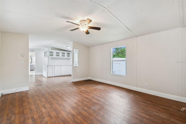 4611 Gall Blvd, Zephyrhills, FL 33542 - unfurnished living room featuring baseboards, wood finished floors, a ceiling fan, and lofted ceiling