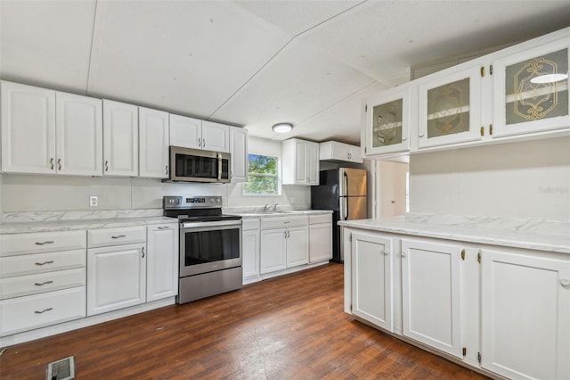 4611 Gall Blvd, Zephyrhills, FL 33542 - kitchen featuring stainless steel appliances, white cabinets, and glass insert cabinets