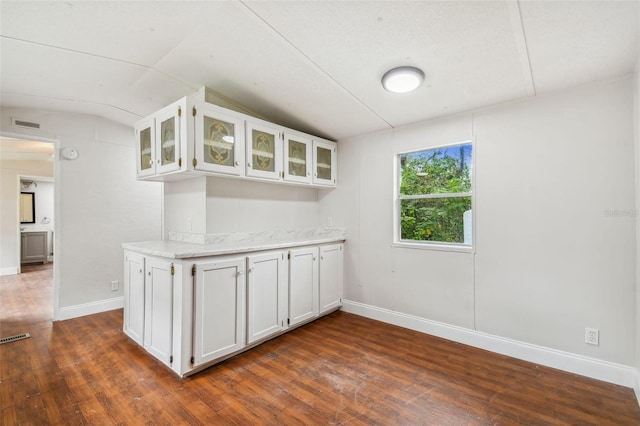 4611 Gall Blvd, Zephyrhills, FL 33542 - kitchen featuring baseboards, dark wood finished floors, white cabinets, and glass insert cabinets