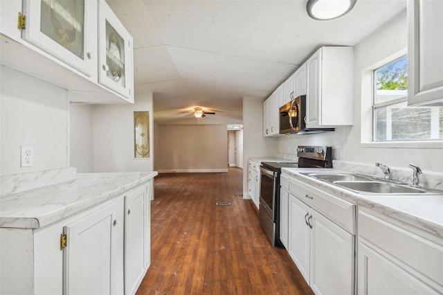 4611 Gall Blvd, Zephyrhills, FL 33542 - kitchen with a sink, white cabinets, dark wood-type flooring, light countertops, and appliances with stainless steel finishes