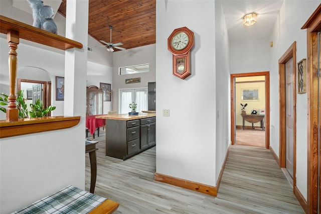 hallway featuring french doors, high vaulted ceiling, wood ceiling, and light hardwood / wood-style flooring