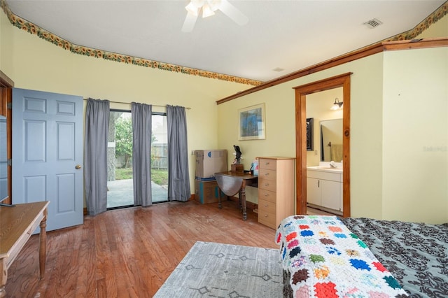 bedroom with ensuite bathroom, access to outside, ceiling fan, hardwood / wood-style flooring, and lofted ceiling