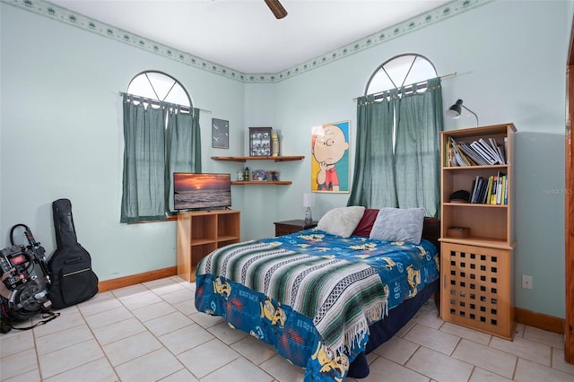 bedroom with ceiling fan and light tile patterned floors