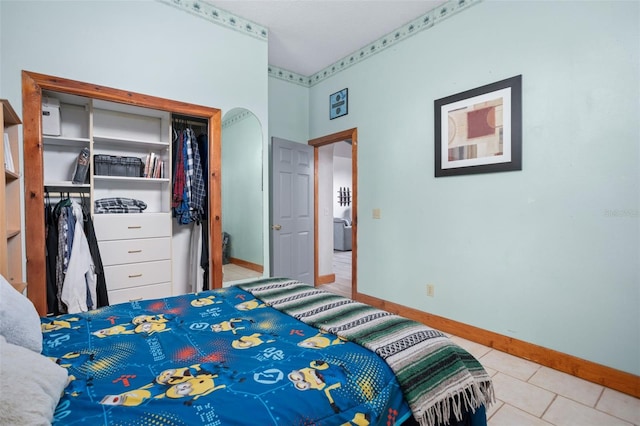 tiled bedroom featuring a closet