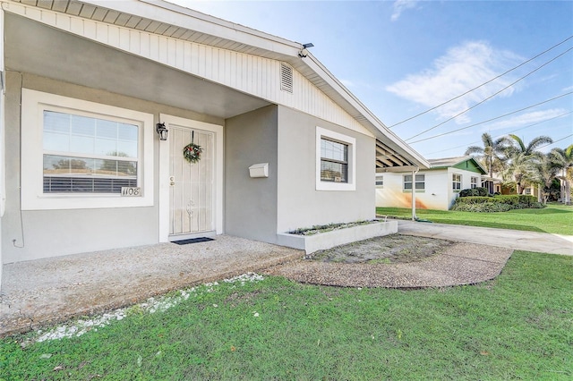 doorway to property featuring a yard