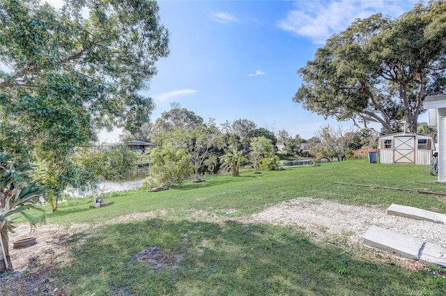 view of yard with a water view and a storage unit