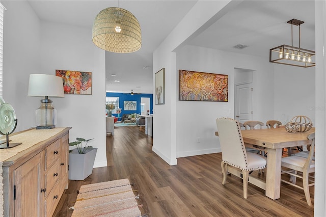 dining room with ceiling fan and dark hardwood / wood-style flooring