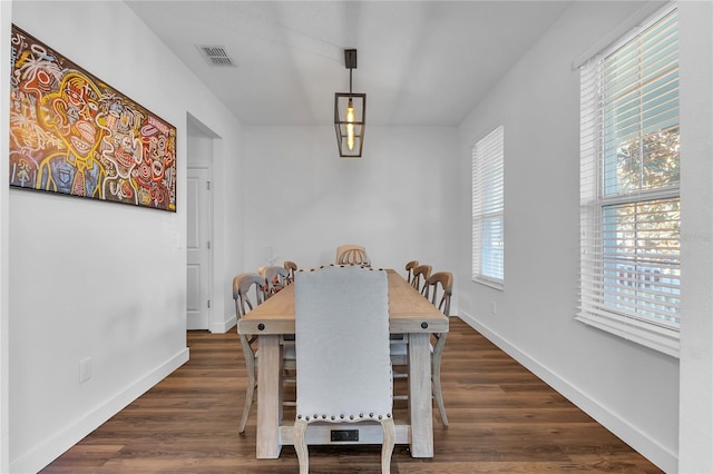 dining space featuring dark hardwood / wood-style flooring and a healthy amount of sunlight