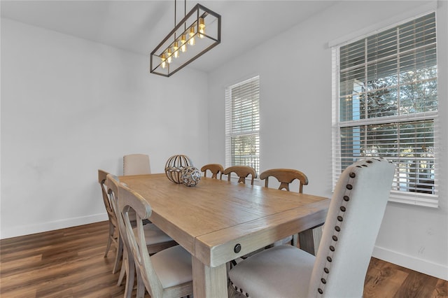 dining space with dark wood-type flooring