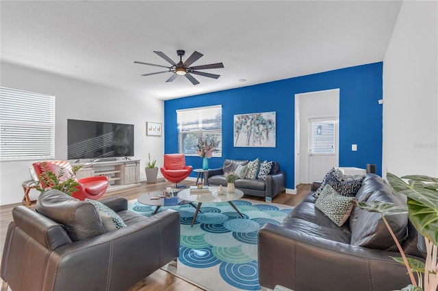 living room featuring plenty of natural light, ceiling fan, and wood-type flooring