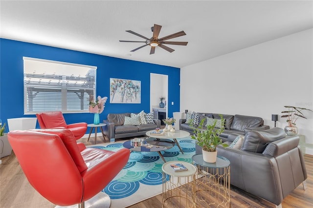 living room with ceiling fan and light hardwood / wood-style flooring