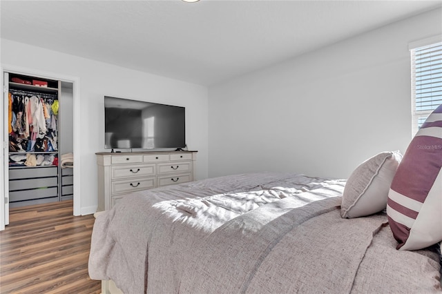 bedroom featuring dark hardwood / wood-style flooring and a closet