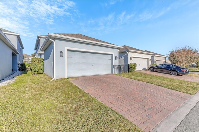 view of front of property with a garage and a front lawn