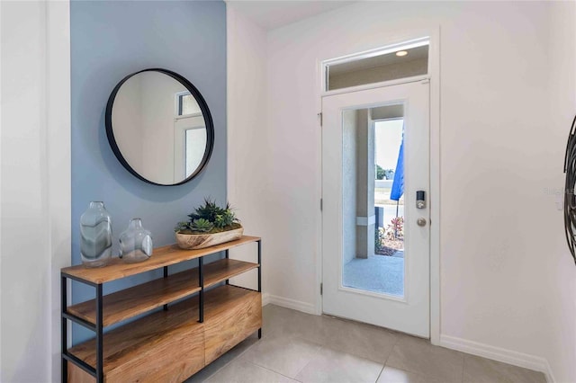 doorway to outside with light tile patterned floors