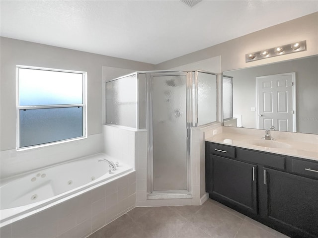 bathroom featuring tile patterned floors, vanity, and shower with separate bathtub