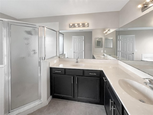 bathroom with tile patterned floors, vanity, and a shower with door