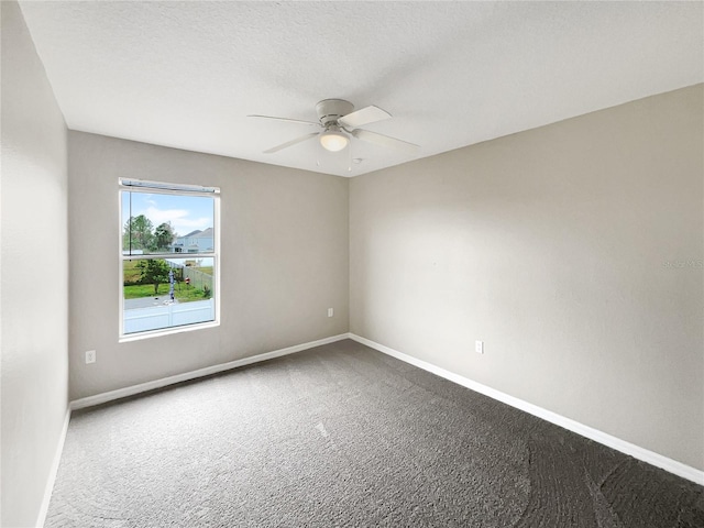 carpeted empty room featuring a textured ceiling and ceiling fan