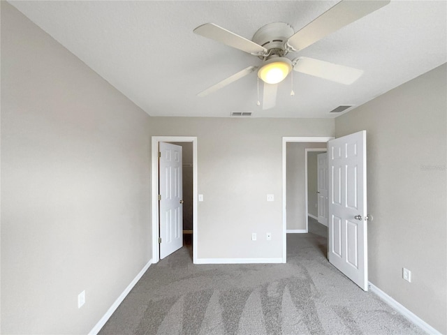 unfurnished bedroom with light colored carpet and ceiling fan