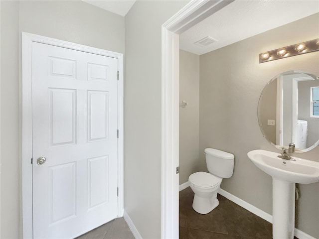 bathroom featuring tile patterned floors, sink, and toilet