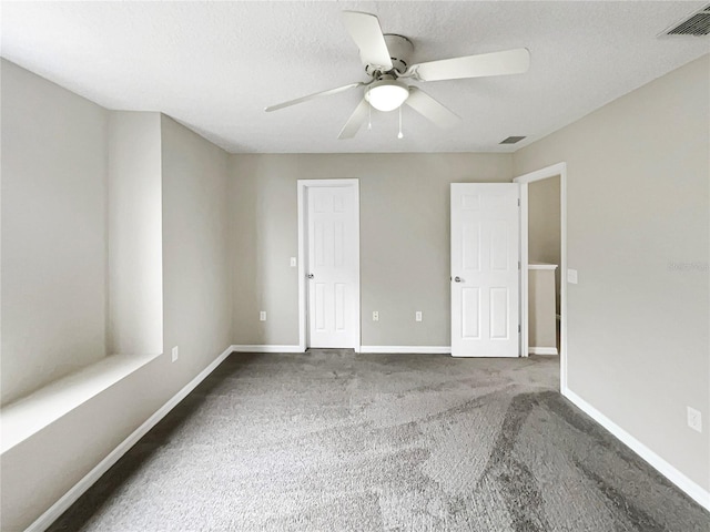 empty room featuring carpet, ceiling fan, and a textured ceiling