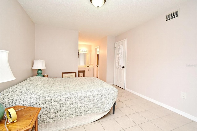 bedroom featuring tile patterned flooring and a textured ceiling