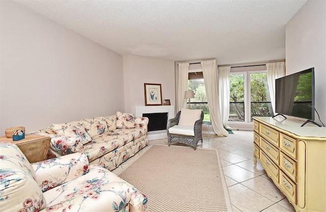 living room featuring light tile patterned floors and a textured ceiling