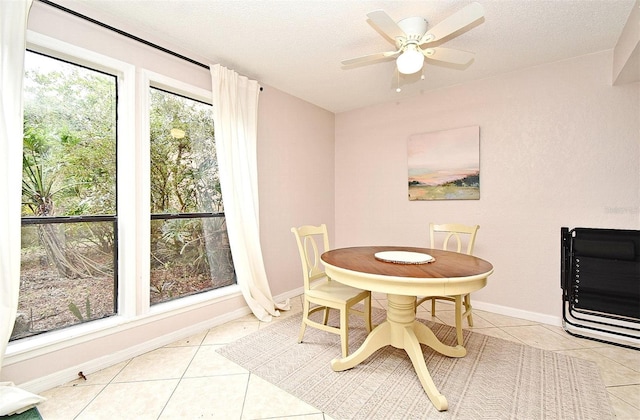 tiled dining area featuring ceiling fan and a textured ceiling