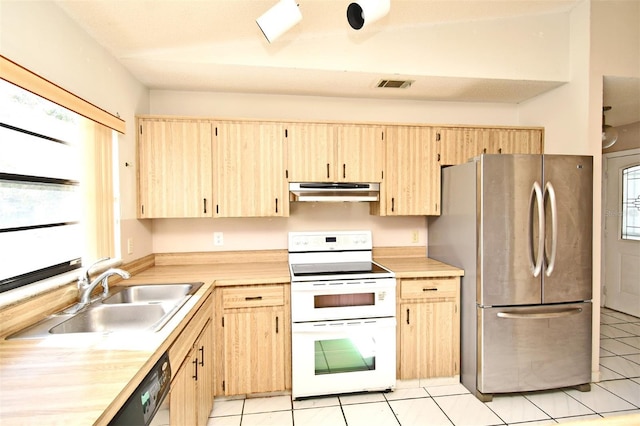 kitchen featuring light brown cabinetry, stainless steel refrigerator, sink, and white electric range oven