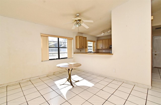 unfurnished room with track lighting and ceiling fan