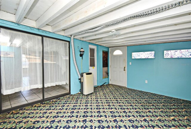 unfurnished sunroom featuring beam ceiling