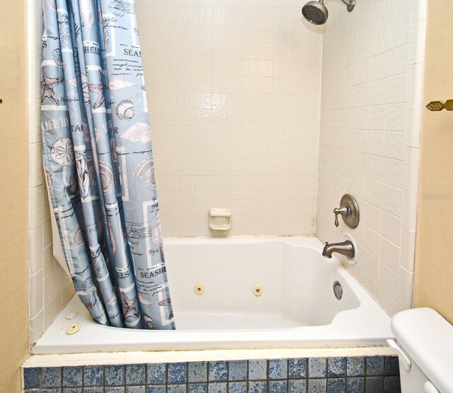 bathroom with shower / bath combo and toilet