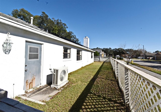 view of home's exterior featuring a lawn and ac unit