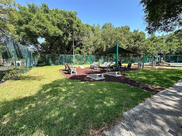 surrounding community featuring a playground and a yard