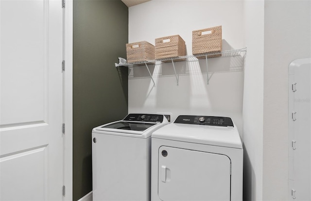 clothes washing area featuring washer and dryer