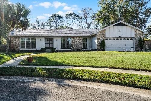 ranch-style home with a front yard and a garage