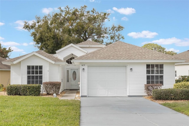 view of front of home with a garage and a front lawn