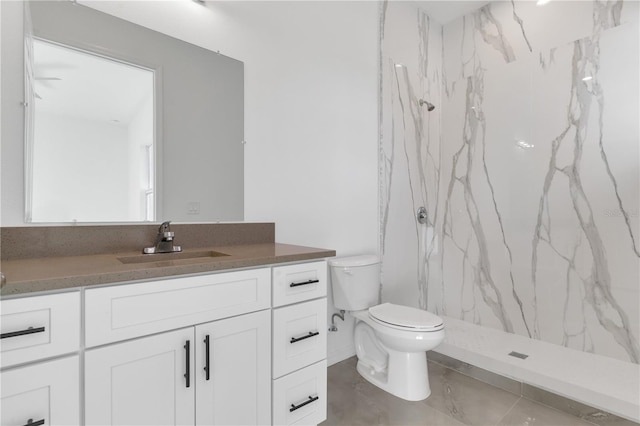 bathroom featuring a shower, vanity, and toilet