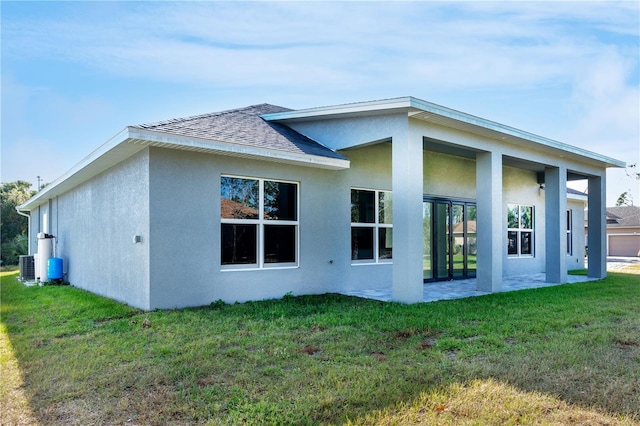 view of property exterior featuring a lawn and central air condition unit