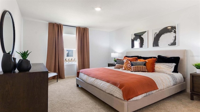 bedroom featuring light carpet