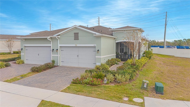1987 Key Bay Trl, Kissimmee, FL 34747 - view of front of property featuring stucco siding, driveway, and a garage