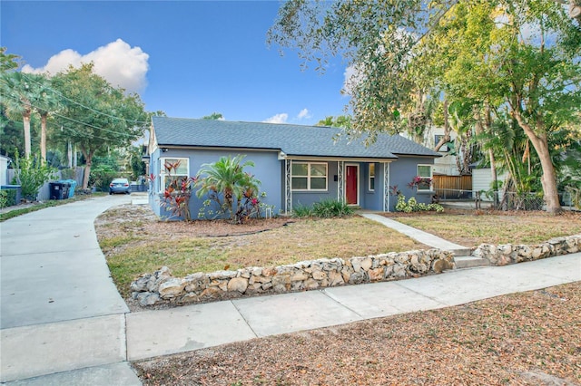 ranch-style home with a front lawn