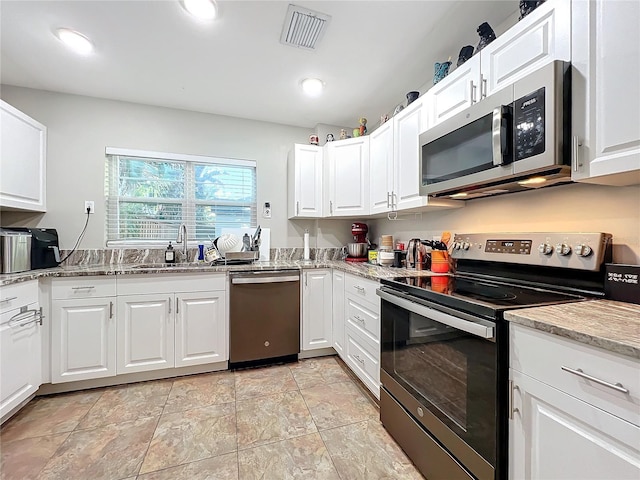 kitchen with sink, white cabinets, and stainless steel appliances