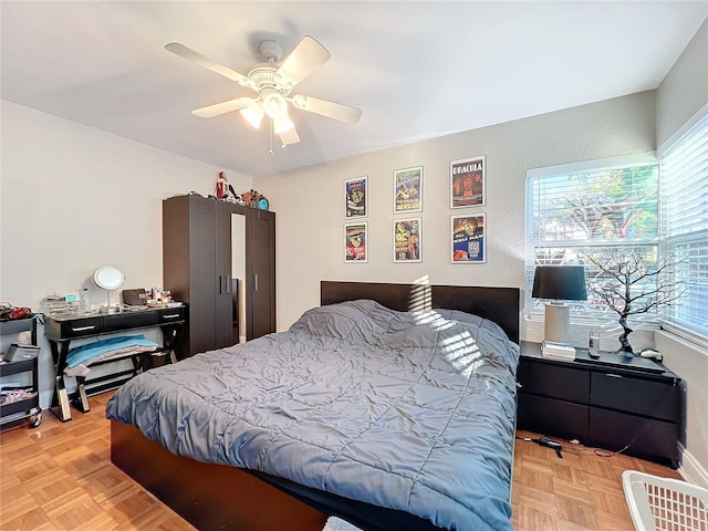 bedroom with light parquet floors and ceiling fan