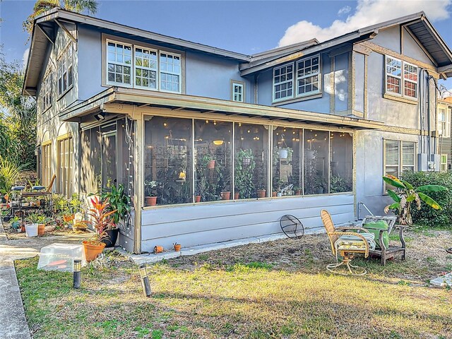 view of side of property with a sunroom