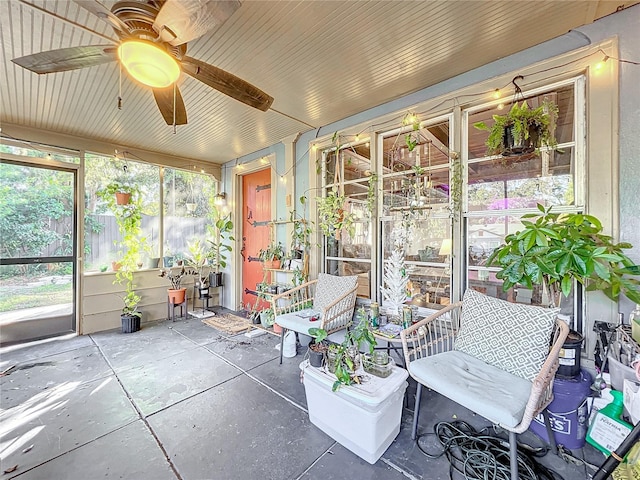 sunroom / solarium featuring plenty of natural light and ceiling fan