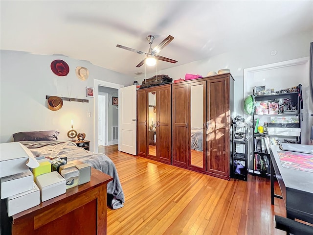 bedroom with light hardwood / wood-style floors and ceiling fan